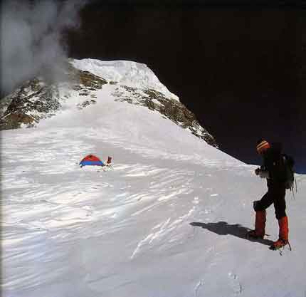
Reinhold Messner at Camp 4 on K2 Shoulder With Bottlebeck and route to summit above - K2: Mountain Of Mountains book
